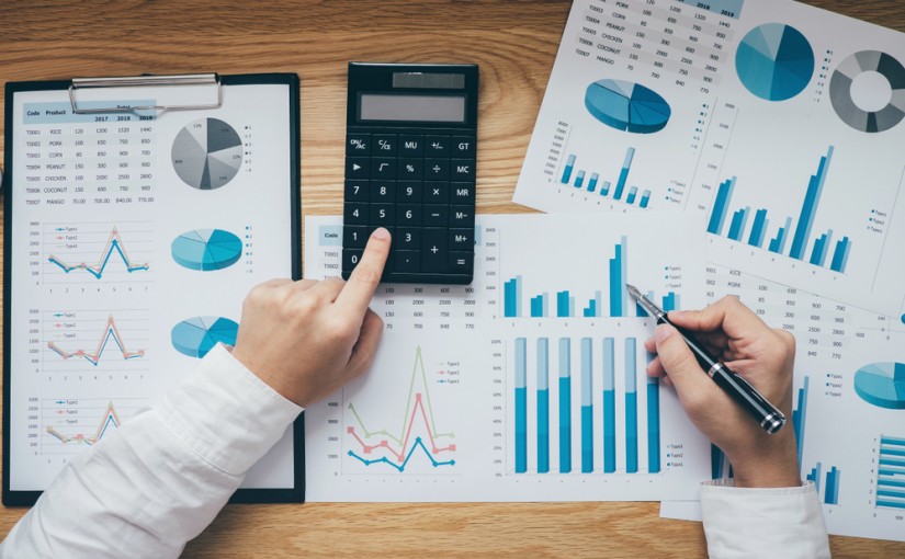 Businessman,Working,On,A,Graph,Document,Financial,Report,And,Analysis