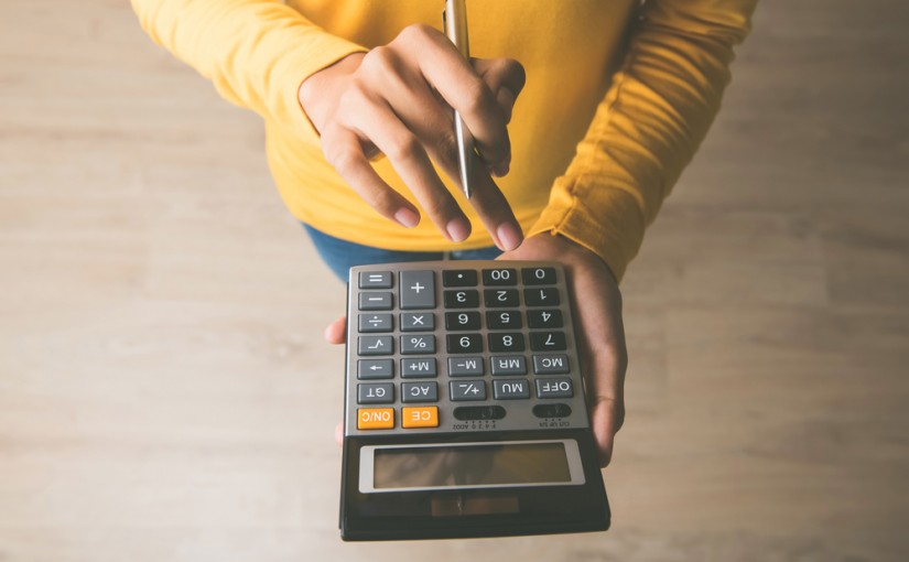 Woman,Entrepreneur,Using,A,Calculator,With,A,Pen,In,Her